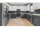 Kitchen featuring stainless steel appliances, stylish backsplash, and two-tone cabinets at 1657 Bradmere Ln, Lithia Springs, GA 30122