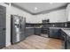 Well-equipped kitchen with stainless steel appliances, tile backsplash, and two tone cabinets at 1657 Bradmere Ln, Lithia Springs, GA 30122