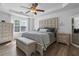 Comfortable main bedroom with tray ceiling, furniture set, and plush bedding at 1657 Bradmere Ln, Lithia Springs, GA 30122