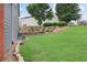 Exterior view showcasing a well-maintained lawn with landscaping, retaining wall and exterior home features at 1657 Bradmere Ln, Lithia Springs, GA 30122
