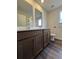 Bathroom features a dual vanity, wood-look flooring and multiple mirrors at 2277 Whitworth St, Lawrenceville, GA 30044
