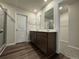 Bathroom featuring a dual vanity, wood-look flooring, and a separate shower at 2277 Whitworth St, Lawrenceville, GA 30044