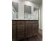 Bathroom features a dual vanity, wood-look flooring and multiple mirrors at 2277 Whitworth St, Lawrenceville, GA 30044