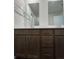 Bathroom features a dual vanity, wood-look flooring and multiple mirrors at 2277 Whitworth St, Lawrenceville, GA 30044