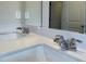Close-up of a bathroom vanity with dual sinks, modern chrome faucets, and a large mirror at 2277 Whitworth St, Lawrenceville, GA 30044