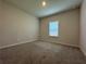 This bedroom features neutral walls and floors and a window with natural light at 2277 Whitworth St, Lawrenceville, GA 30044