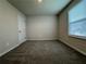 Cozy bedroom with plush carpeting, neutral walls, and a window for natural light at 2277 Whitworth St, Lawrenceville, GA 30044