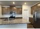 Well-equipped kitchen features granite counters, stainless appliances, and custom cabinetry at 2277 Whitworth St, Lawrenceville, GA 30044