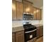 Modern kitchen with stainless steel range, custom cabinets, and granite countertops at 2277 Whitworth St, Lawrenceville, GA 30044