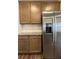 Modern kitchen features stainless refrigerator, custom cabinets, and granite countertops at 2277 Whitworth St, Lawrenceville, GA 30044