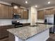 Well-equipped kitchen features an island, stainless steel appliances, and custom cabinetry at 2277 Whitworth St, Lawrenceville, GA 30044