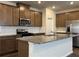 Stylish kitchen features granite island, stainless appliances, and custom cabinets at 2277 Whitworth St, Lawrenceville, GA 30044