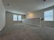 This expansive living area features soft carpeting, neutral walls and multiple windows at 2277 Whitworth St, Lawrenceville, GA 30044
