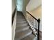 Carpeted staircase with decorative wooden railing at 2277 Whitworth St, Lawrenceville, GA 30044