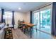 Bright basement dining area with stylish table, chairs and sliding glass doors to outdoors at 2849 Crescendo Dr, Atlanta, GA 30318