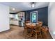 Open dining area featuring hardwood floors, modern decor, natural light and a view to the kitchen at 2849 Crescendo Dr, Atlanta, GA 30318