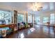 This living room features a ceiling fan, hardwood floors, several windows and built in shelving at 2849 Crescendo Dr, Atlanta, GA 30318