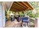 This outdoor patio features a grill, multiple chairs, a table and a beautiful view of the trees at 2849 Crescendo Dr, Atlanta, GA 30318