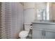 Charming bathroom featuring a shower with striped curtain, and vanity with sink and cabinets at 4202 Deming Cir, Sandy Springs, GA 30342
