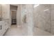 Elegant bathroom showcasing white marble walls, glass-enclosed shower, and modern fixtures at 4202 Deming Cir, Sandy Springs, GA 30342