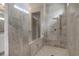 Luxurious bathroom features a walk-in shower with marble tile, a bench, and a sleek design at 4202 Deming Cir, Sandy Springs, GA 30342