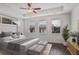 Bright bedroom boasts three windows, a ceiling fan, and neutral decor with space for a sitting area at 4202 Deming Cir, Sandy Springs, GA 30342