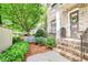 Charming brick home entrance featuring landscaped garden, a blue bench and a decorative front door at 4202 Deming Cir, Sandy Springs, GA 30342