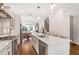Bright, modern kitchen featuring a large island, stainless appliances, and open layout to dining area at 4202 Deming Cir, Sandy Springs, GA 30342