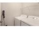 Bright laundry room with washer, dryer, and wire shelving at 4202 Deming Cir, Sandy Springs, GA 30342