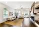 Cozy living room featuring a fireplace, hardwood floors, and large windows at 4202 Deming Cir, Sandy Springs, GA 30342