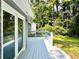 Outdoor deck with serene wooded views, blue siding, and French door access from inside at 4970 Clubgreen Smt, Stone Mountain, GA 30088
