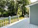 Back deck overlooking the wooded yard with gray painted deck and railings at 4970 Clubgreen Smt, Stone Mountain, GA 30088