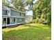 Home backyard featuring a deck, lush grass, trees and privacy at 4970 Clubgreen Smt, Stone Mountain, GA 30088