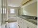 Bright bathroom with a double sink vanity, soaking tub, and a separate glass shower at 4970 Clubgreen Smt, Stone Mountain, GA 30088