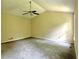 Spacious carpeted bedroom with a ceiling fan and natural light from the window at 4970 Clubgreen Smt, Stone Mountain, GA 30088