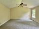 Well-lit primary bedroom featuring neutral walls, carpeted flooring, and a ceiling fan at 4970 Clubgreen Smt, Stone Mountain, GA 30088