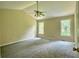 Bedroom with neutral walls and carpet, large windows and modern ceiling fan with light fixture at 4970 Clubgreen Smt, Stone Mountain, GA 30088