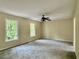 Large bedroom with two windows, carpet flooring and neutral walls, offering ample space and natural light at 4970 Clubgreen Smt, Stone Mountain, GA 30088