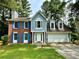 Charming two-story home with a well-manicured lawn, classic brick, and blue shutters at 4970 Clubgreen Smt, Stone Mountain, GA 30088