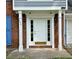 Inviting front door with white columns and sidelights, creating a warm entrance at 4970 Clubgreen Smt, Stone Mountain, GA 30088