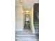 Hallway with modern wood-look floors leading to a stairwell and rooms ahead at 4970 Clubgreen Smt, Stone Mountain, GA 30088