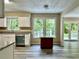 Bright kitchen features white cabinets, stainless steel appliances, gray counters, and a red kitchen island at 4970 Clubgreen Smt, Stone Mountain, GA 30088