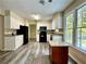Bright kitchen with white cabinets, gray countertops, black appliances, and a center kitchen island at 4970 Clubgreen Smt, Stone Mountain, GA 30088