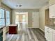 Spacious kitchen featuring white cabinets, granite counters, stainless appliances, and a view into the living room at 4970 Clubgreen Smt, Stone Mountain, GA 30088