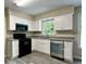 Kitchen featuring white cabinets, granite countertops, and stainless steel appliances at 4970 Clubgreen Smt, Stone Mountain, GA 30088
