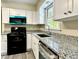 Kitchen featuring white cabinets, granite countertops, and stainless steel appliances at 4970 Clubgreen Smt, Stone Mountain, GA 30088