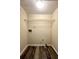 An empty laundry room with hardwood floors, wire rack, and a utility sink hook-up at 4970 Clubgreen Smt, Stone Mountain, GA 30088