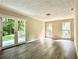Bright living room featuring French doors leading to deck, neutral paint, and gray vinyl floors at 4970 Clubgreen Smt, Stone Mountain, GA 30088