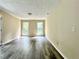 A light filled living room with gray vinyl floors, neutral paint and lots of light from two windows at 4970 Clubgreen Smt, Stone Mountain, GA 30088