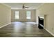 Bright living room with hardwood floors, fireplace, and a ceiling fan at 4970 Clubgreen Smt, Stone Mountain, GA 30088